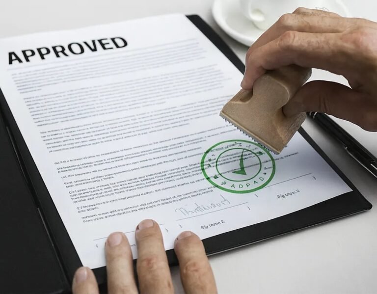 Engineer reviewing and signing construction approval documents for Ajman Municipality, representing full approval management under one roof.